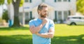 serious mature man realtor standing outdoor at house, broker