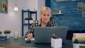 Serious mature middle aged business woman using laptop typing email Royalty Free Stock Photo