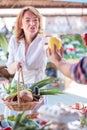 Serious mature woman buying fresh organic vegetables in a local marketplace Royalty Free Stock Photo