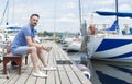 Serious matured man on pier looking away. Royalty Free Stock Photo