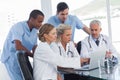 Serious medical team using a laptop Royalty Free Stock Photo