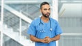 Serious mexican male nurse or doctor with beard and stethoscope