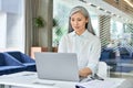 Serious mid age businesswoman executive manager working typing using pc laptop. Royalty Free Stock Photo