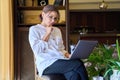 Serious middle aged business woman working with laptop sitting in home office. Royalty Free Stock Photo