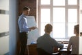 Serious male speaker presenting business strategy on flipchart Royalty Free Stock Photo