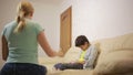 Serious mother lecturing unpleased teenager in home