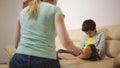 Serious mother lecturing unpleased teenager in home