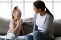 Serious mother talking to sad upset preschooler daughter