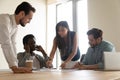 Serious multiethnic business team brainstorm on paperwork at group meeting Royalty Free Stock Photo