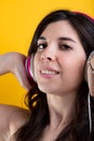 Serious music-lover subtly smiles in pink headphones