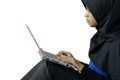 Serious muslim asian lady using laptop