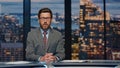 Serious newsreader speaking newscast evening studio closeup. Man broadcasting