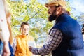 Serious nice boy standing in front of his teacher Royalty Free Stock Photo