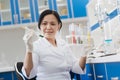 Serious nice woman looking at the test tube