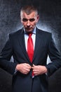 Serious old business man unbuttoning his suit Royalty Free Stock Photo