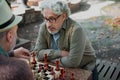 Serious old men playing chess with confidence Royalty Free Stock Photo