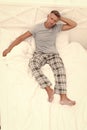 Serious pajama man rest in bed wakening after sleep in morning, resting Royalty Free Stock Photo