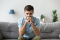 Serious pensive man sitting thinking at home