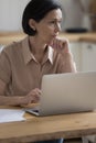 Serious pensive mature freelancer lady working at laptop from home Royalty Free Stock Photo