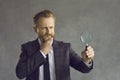 Serious pensive thoughtful man businessman looking through magnifying glass Royalty Free Stock Photo