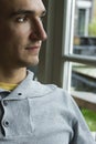 Serious pensive young man sitting in profile Royalty Free Stock Photo