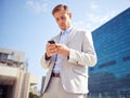 Serious, phone and business man in city for reading email, news or typing on website outdoor in low angle. Mobile Royalty Free Stock Photo