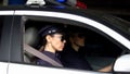 Serious policewomen driving car, traffic laws patrolling, monitoring order Royalty Free Stock Photo