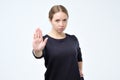 Serious pretty woman making stop hand sign palm gesture Royalty Free Stock Photo