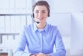 Serious pretty young woman working as support phone operator with headset in office Royalty Free Stock Photo