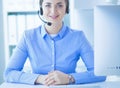 Serious pretty young woman working as support phone operator with headset in office Royalty Free Stock Photo