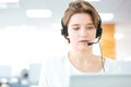 Serious pretty young woman working as support phone operator Royalty Free Stock Photo