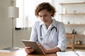 Serious professional doctor using digital tablet computer at work Royalty Free Stock Photo