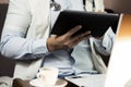 Serious professional doctor in white coat and stethoscope holding modern touch screen gadget using digital tablet computer at work Royalty Free Stock Photo