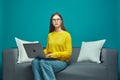 Serious puzzled young girl with laptop sit on sofa, realizing missing deadline, late for appointment, forget meeting