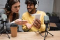 serious radio host in headphones pointing Royalty Free Stock Photo