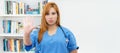 Serious redhead nurse gesturing stop and distance