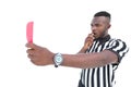 Serious referee showing red card blowing whistle Royalty Free Stock Photo