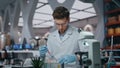 Serious researcher examining liquid in test tubes working laboratory close up. Royalty Free Stock Photo