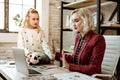 Serious resolute woman in red jacket showing insufferable gesture Royalty Free Stock Photo