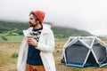 Serious rough outdoor man next to tent in iceland Royalty Free Stock Photo