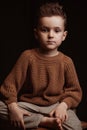 serious sad stylish white caucasian child boy preschooler a chair Royalty Free Stock Photo