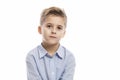 Serious school boy in a blue shirt. Isolated on a white background Royalty Free Stock Photo