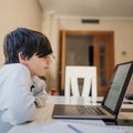 Serious school boy concentrated while studying maths at home. Home school and distance education concept Royalty Free Stock Photo