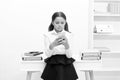 serious school girl messaging at the desk. school girl messaging on phone.