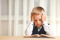 Serious schoolboy reads book Royalty Free Stock Photo