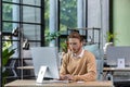 Serious and scorn-centered man in the office at work with a computer, man typing thoughtfully on keyboards, businessman Royalty Free Stock Photo