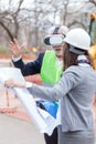 Serious senior architect or businessman using virtual reality goggles to visualize construction project on a construction site