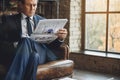 Serious senior businessman reading news Royalty Free Stock Photo