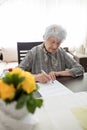 Senior woman doing Alzheimer`s disease or dementia self diagnosis test at home