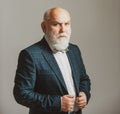 Serious Senior. Confident senior bearded man in a suit and tie stand on gray isolated background. Fashion adult.